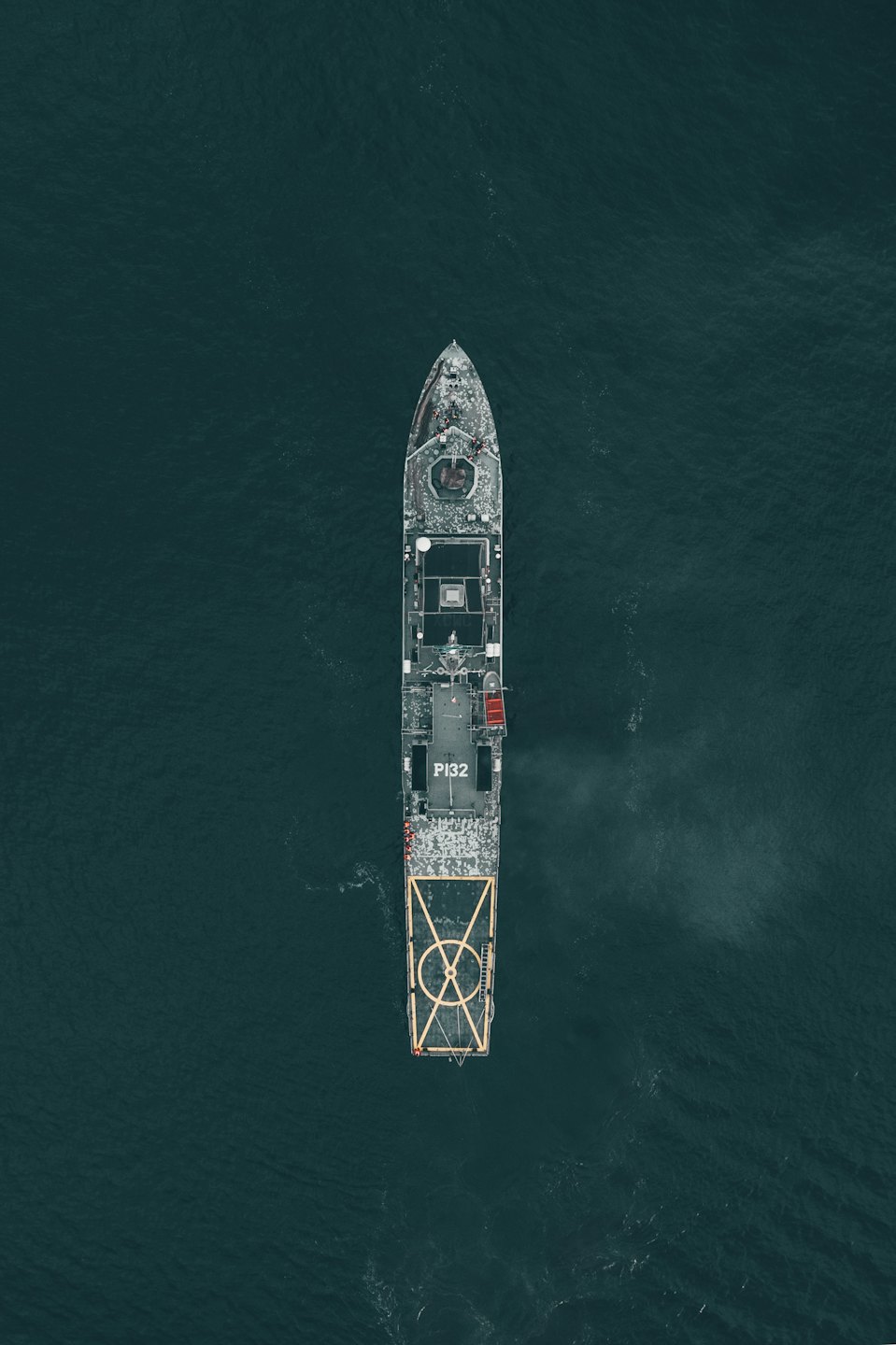 Grey patrol vessel P132 sailing across the open ocean.
