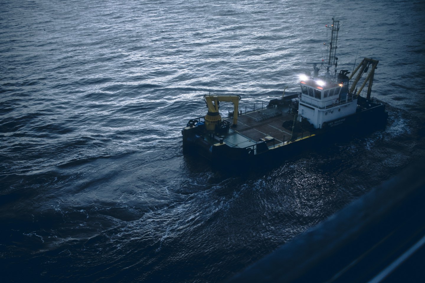 CDY SEAHORSE workboat moving through dark, choppy water at night.
